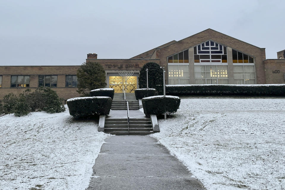 A menorah stands outside the entrance to Temple Israel, Thursday, Dec. 7, 2023, in Albany, N.Y. A 28-year-old suspect was in police custody for allegedly firing two rounds from a shotgun outside the Jewish temple on Friday, just hours before the start of Hanukkah. Officials said no one was injured and police they did not know the man's motive.(AP Photo/Maysoon Khan)