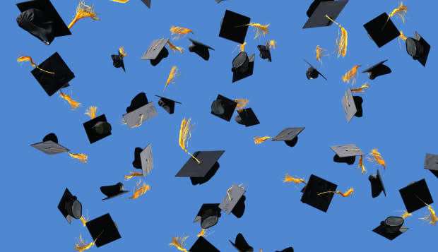 Graduation caps thrown into air