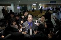 A South Korean employee working at North Korea's Kaesong Industrial Complex (KIC) is surrounded by media at the South's CIQ (Customs, Immigration and Quarantine), just south of the demilitarised zone separating the two Koreas, in Paju, South Korea, February 11, 2016. REUTERS/Kim Hong-Ji