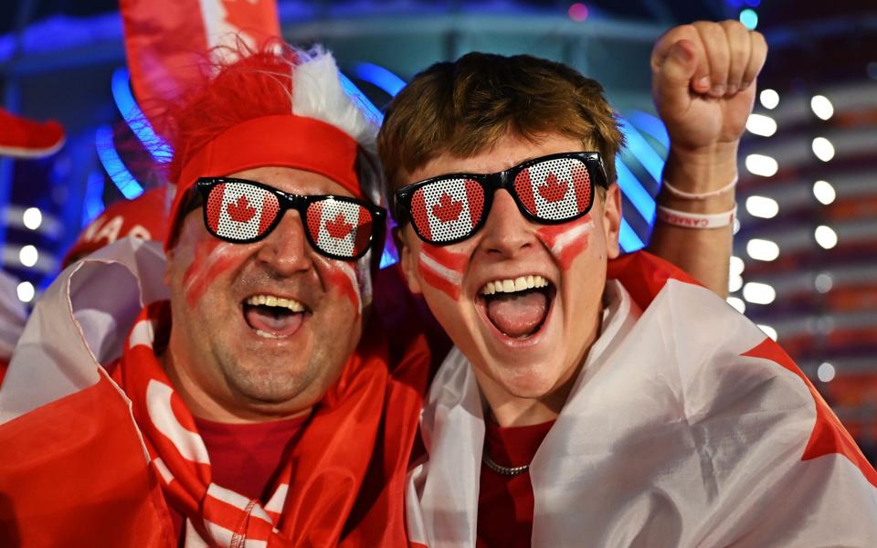 Fans of Canada cheer while posing ahead of the FIFA World Cup 2022 group F soccer match between Croatia and Canada at Khalifa International Stadium - Noushad Thekkayil/Shutterstock