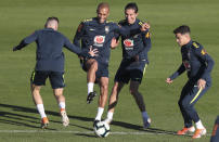 Arthur, Miranda, Filipe Luis and Phlippe Coutinho, from left to right, play with a ball during a training session of Brazil national soccer team in Porto Alegre, Brazil, Wednesday, June 26, 2019. Brazil will play against Paraguay for a Copa America quarter-final match on June 27.(AP Photo/Natacha Pisarenko)