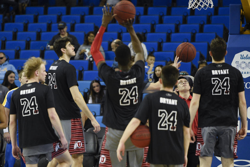 Utah players wear shirts with No. 24 on the back in honor of late Los Angeles Lakers player Kobe Bryant while warming up prior to an NCAA college basketball game against UCLA in Los Angeles, Sunday, Feb. 2, 2020. (AP Photo/Kelvin Kuo)