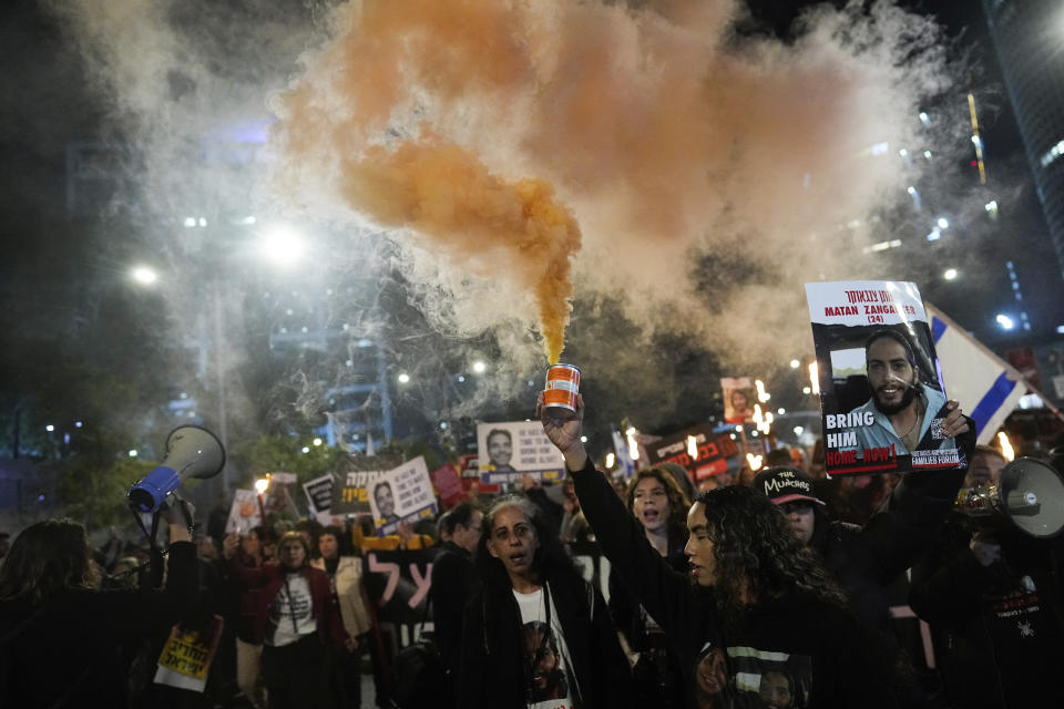 FILE - Demonstrators wave signs and shout slogans during a protest calling for the release of hostages held in the Gaza Strip by the Hamas militant group, in Tel Aviv, Israel, Saturday, Feb. 24, 2024. (AP Photo/Ohad Zwigenberg, File)