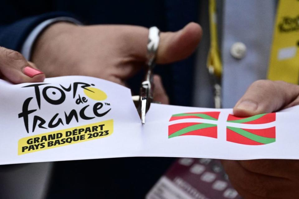 The start line ribbon is cut at the start of the 1st stage of the 110th edition of the Tour de France cycling race 182 km departing and finishing in Bilbao in northern Spain on July 1 2023 Photo by Marco BERTORELLO  AFP Photo by MARCO BERTORELLOAFP via Getty Images