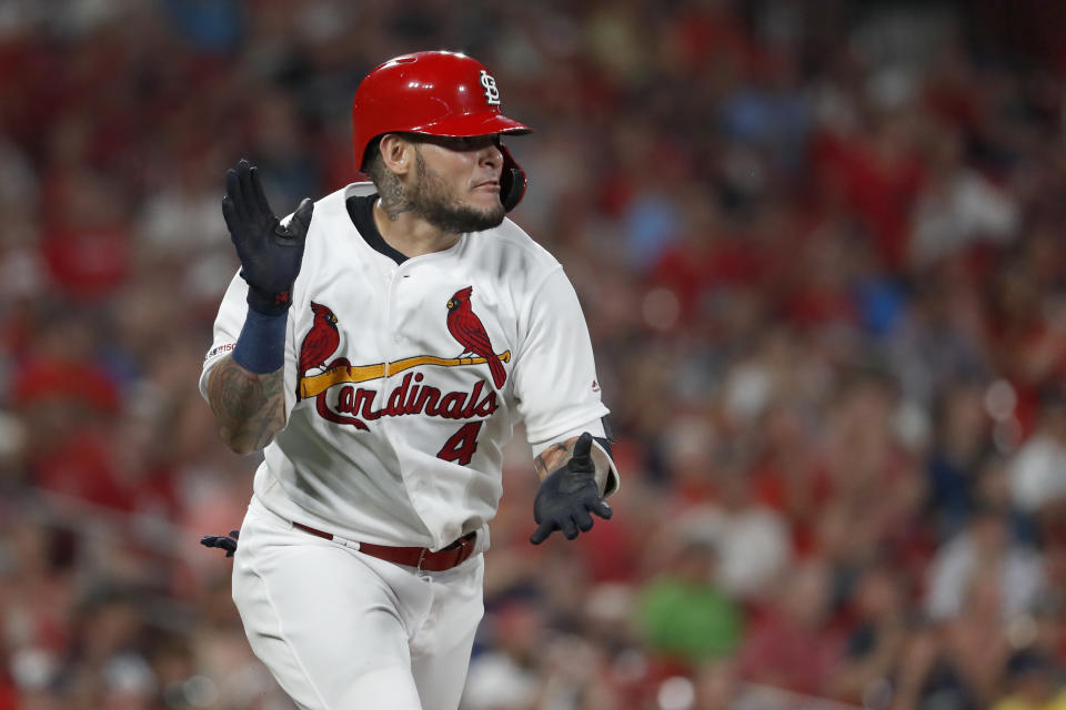 St. Louis Cardinals' Yadier Molina applauds as he runs up the line after hitting a single during the fifth inning of a baseball game against the Milwaukee Brewers, Monday, Aug. 19, 2019, in St. Louis. (AP Photo/Jeff Roberson)