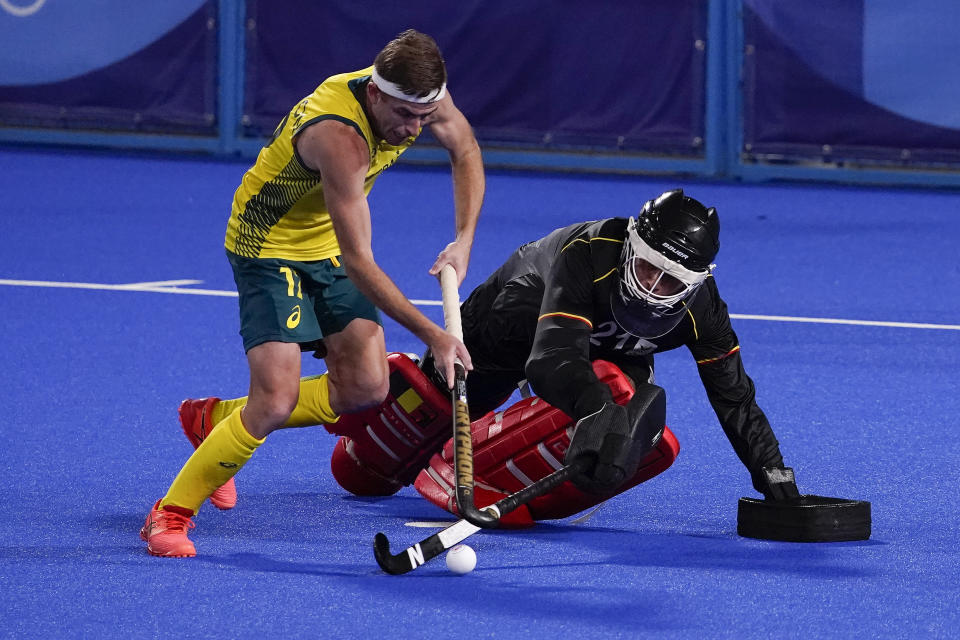 Belgium goalkeeper Vincent Vanasch (21) blocks a shot by Australia's Jacob Thomas Whetton (12) during a shootout to win the men's gold medal field hockey match at the 2020 Summer Olympics, Thursday, Aug. 5, 2021, in Tokyo, Japan. (AP Photo/John Locher)