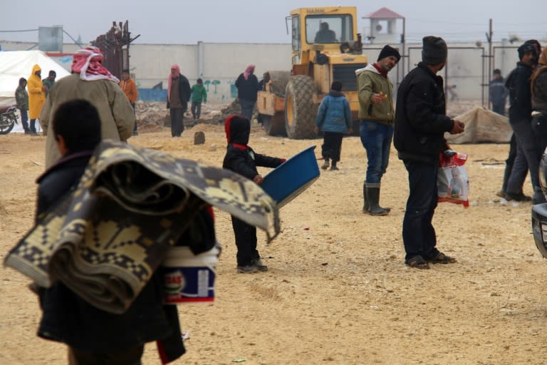 Displaced Syrians fleeing areas in the northern embattled province of Aleppo, gather at the Bab al-Salama camp, set up outside the Syrian city of Azaz on the border with Turkey, on February 12, 2016