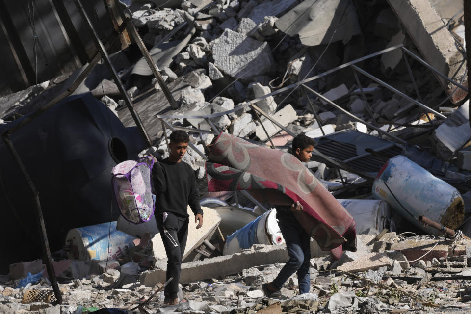 Palestinians visit their houses destroyed in the Israeli bombings in Al-Zahra, on the outskirts of Gaza City, on Thursday, Nov. 30, 2023. during the temporary ceasefire between Hamas and Israel. (AP Photo/Adel Hana)