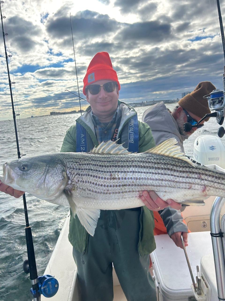 Stuart Lombardi, Demarest holds a striped bass landed on the Hi Flier charter boat.