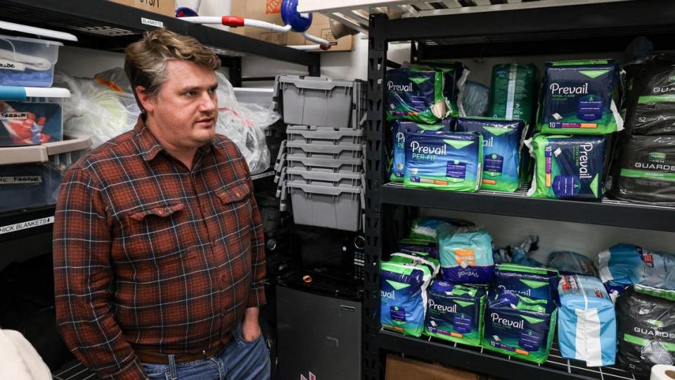 Jack Lahey is director of homeless services at CAPSLO, working at 40 Prado homeless services center in San Luis Obispo. He is standing in a room with supplies for clients on Jan 4, 2023.