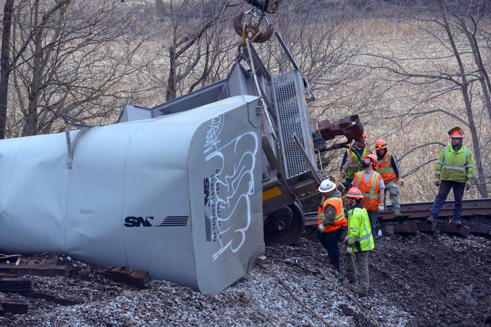 Workers, on Thursday, look over rail cars that derailed Wednesday evening near Sharpsburg. The train was operated by Norfolk Southern.