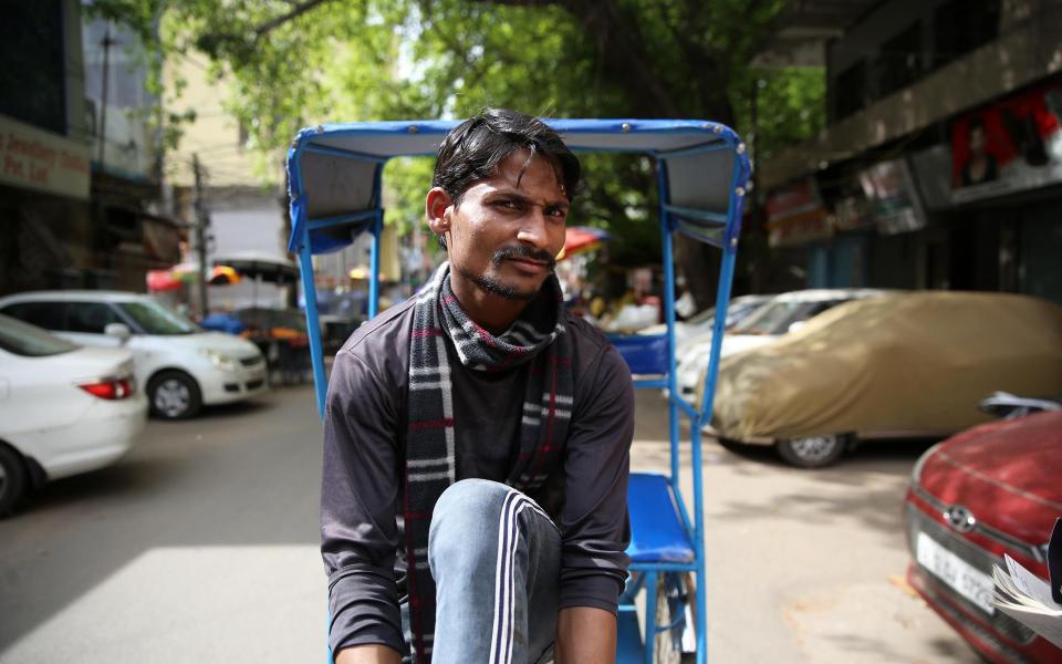 Muhammad Asif, 21, says despite the lockdown he will carry on driving his rickshaw to feed his family - Cheena Kapoor