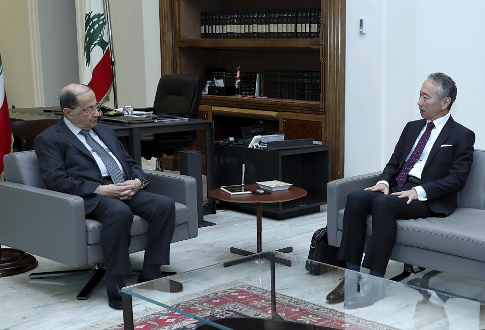 In this photo released by Lebanon's official government photographer Dalati Nohra, Lebanese president Michel Aoun, left, meets with Japan's Ambassador to Lebanon Takeshi Okubo in the presidential palace, in Baabda, east of Beirut, Lebanon, Monday, Sept. 2, 2019. The Lebanese presidential palace said Tuesday that Lebanon's president met with the Japanese ambassador and they discussed the case, but did not provide any other details. This is the first known meeting between the president and a Japanese diplomat since Ghosn arrived in the country on Dec. 30. (Dalati Nohra via AP)