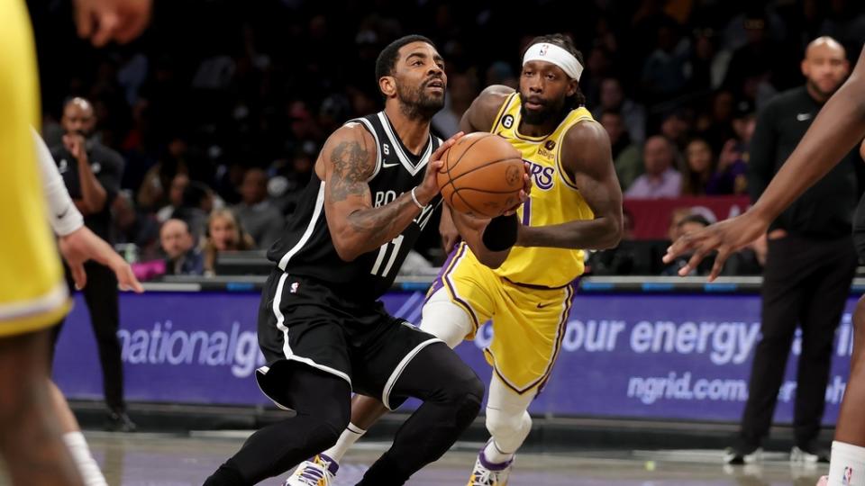 Jan 30, 2023;  Brooklyn, New York, USA;  Brooklyn Nets guard Kyrie Irving (11) takes a shot against Los Angeles Lakers guard Patrick Beverley (21) during the first quarter at Barclays Center.