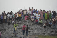 <p>People gather to watch search operations in the Machchu river where a pedestrian bridge collapsed Sunday in Morbi town of western state Gujarat, India, Monday, Oct. 31, 2022. A century-old cable suspension bridge collapsed into the river Sunday evening, sending hundreds plunging in the water in one of the country's worst accidents in years. (AP Photo/Ajit Solanki)</p> 