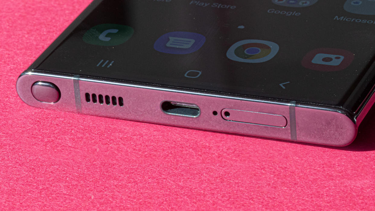 Close-up of the base of Samsung&#39;s Galaxy S22 Ultra on a pink background.