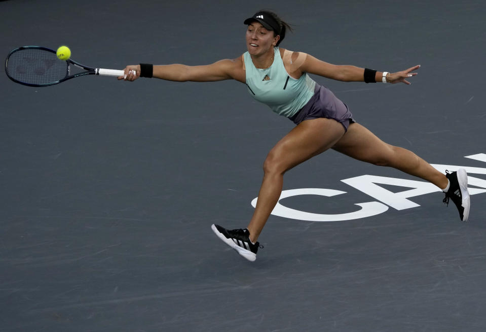 Jessica Pegula, of the United States, returns the ball during a women's singles final of the WTA Finals tennis championships against Iga Swiatek, of Poland, in Cancun, Mexico, Monday, Nov. 6, 2023. (AP Photo/Fernando Llano)
