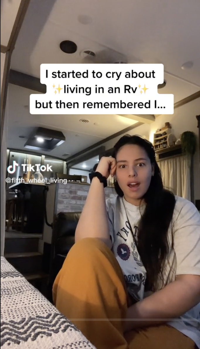 Kirs sitting down with the caption, "I started to cry about living in an RV but then I remembered I..."