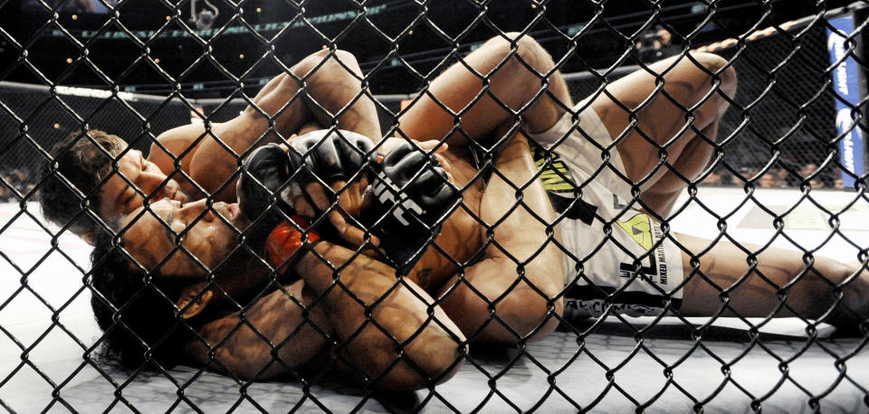 Josh Thomson, back, wrestles Benson Henderson, front, during the main event of the UFC mixed martial arts event in Chicago, Saturday, Jan., 25, 2014. (AP Photo/Paul Beaty)