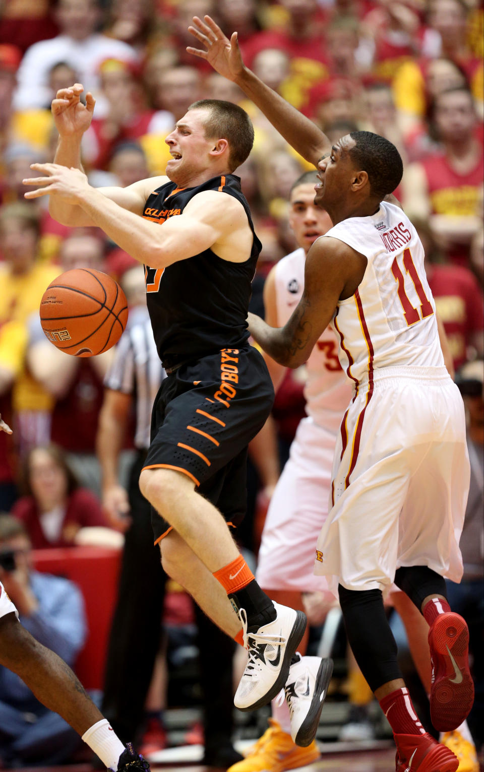 Oklahoma State guard Phil Forte III, left, loses the ball as he is defended by Iowa State guard Monte Morris during the first half of an NCAA college basketball game in Ames, Iowa, Saturday, March 8, 2014. (AP Photo/Justin Hayworth)