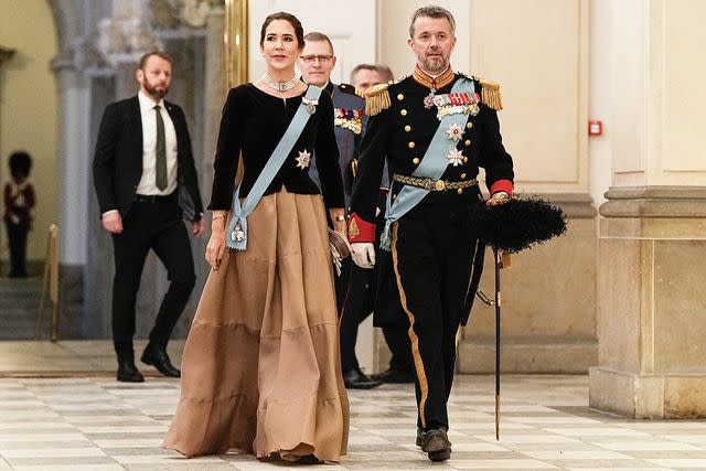 <p>Martin Mads Claus Rasmussen/Ritzau Scanpix/AFP/Getty</p> Crown Princess Mary and Crown Prince Frederik enter the New Year's reception at Christiansborg Palace on Jan. 4.