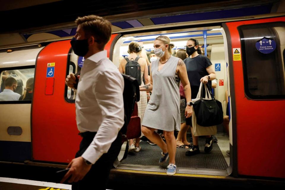 Commuters disembark from a busy carriage (AFP/Getty)