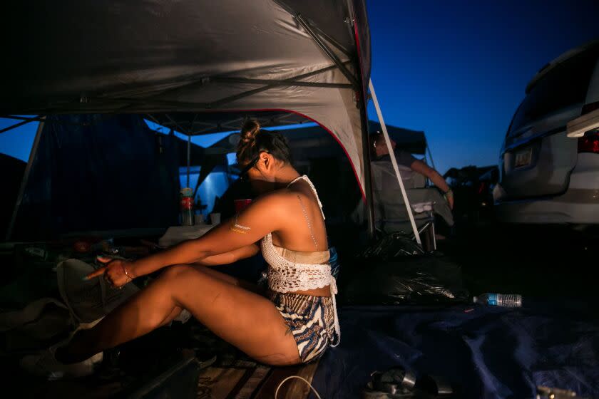 INDIO, CALIF. -- FRIDAY, APRIL 17, 2015: Dina Sam dances to music played at her tent on the camp site during Week 2 of the Coachella Valley Music and Arts Festival in Indio, Calif., on April 17, 2015. (Marcus Yam / Los Angeles Times)