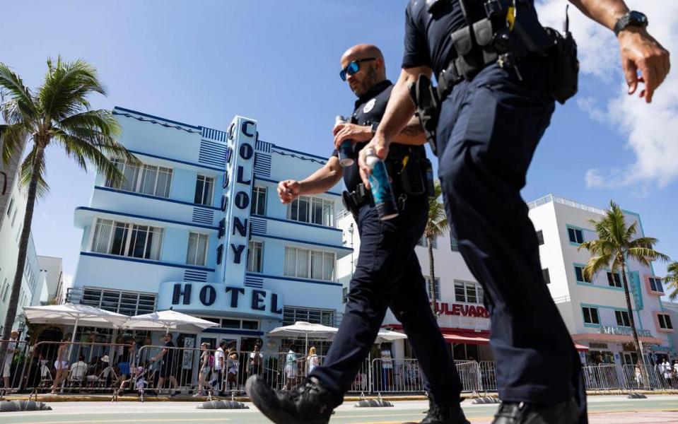 Police officers patrol Ocean Drive during spring break on Friday, March 15, 2024, in Miami Beach. 