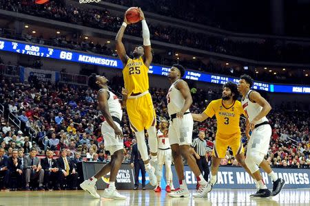 Mar 21, 2019; Des Moines, IA, United States; Minnesota Golden Gophers center Daniel Oturu (25) shoots the ball against Louisville Cardinals guard Christen Cunningham (1) during the second half in the first round of the 2019 NCAA Tournament at Wells Fargo Arena. Mandatory Credit: Steven Branscombe-USA TODAY Sports