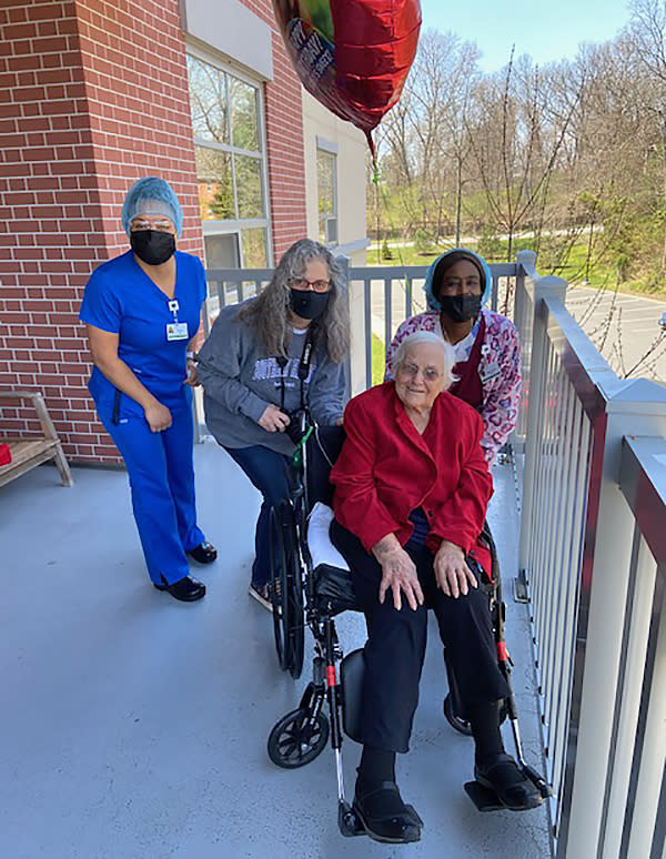 Staff members pose with a resident of Jewish Senior Services in Bridgeport, Conn. (Jewish Senior Services)