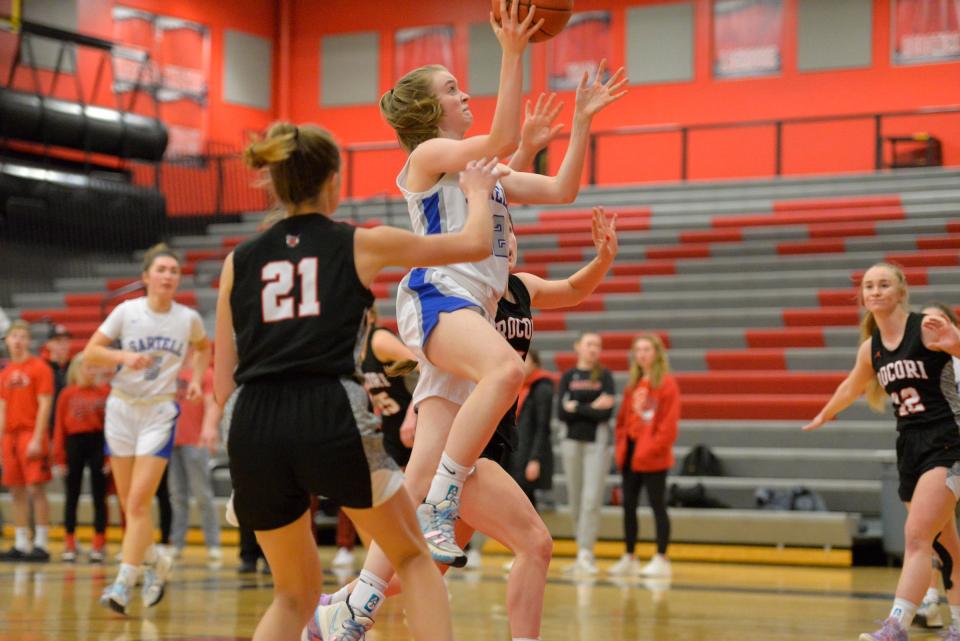 Sartell's Brenna McClure goes up for a contested lay up as ROCORI battles Sartell at ROCORI High School on Tuesday, Jan. 25, 2022. 
