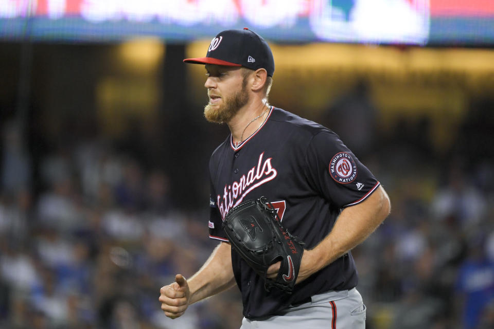 Washington Nationals starting pitcher Stephen Strasburg smiles after the last out in the third inning against the Los Angeles Dodgers in Game 2 of a baseball National League Division Series on Friday, Oct. 4, 2019, in Los Angeles. (AP Photo/Mark J. Terrill)
