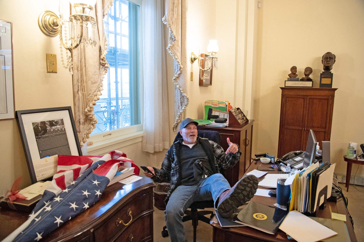 Richard Barnett sits in the office of House Speaker Nancy Pelosi on Jan. 6, 2021. (Saul Loeb / AFP via Getty Images)