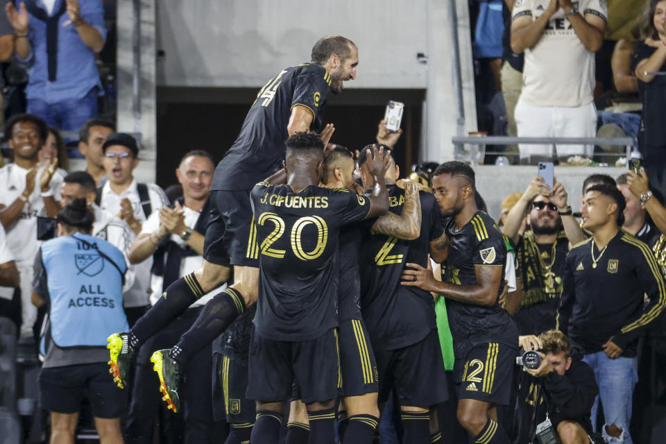 Los Angeles FC defender Giorgio Chiellini jumps to celebrate with teammates after forward Kwadwo Opoku scored against the Seattle Sounders during the first half of an MLS soccer match Friday, July 29, 2022, in Los Angeles. (AP Photo/Ringo H.W. Chiu)