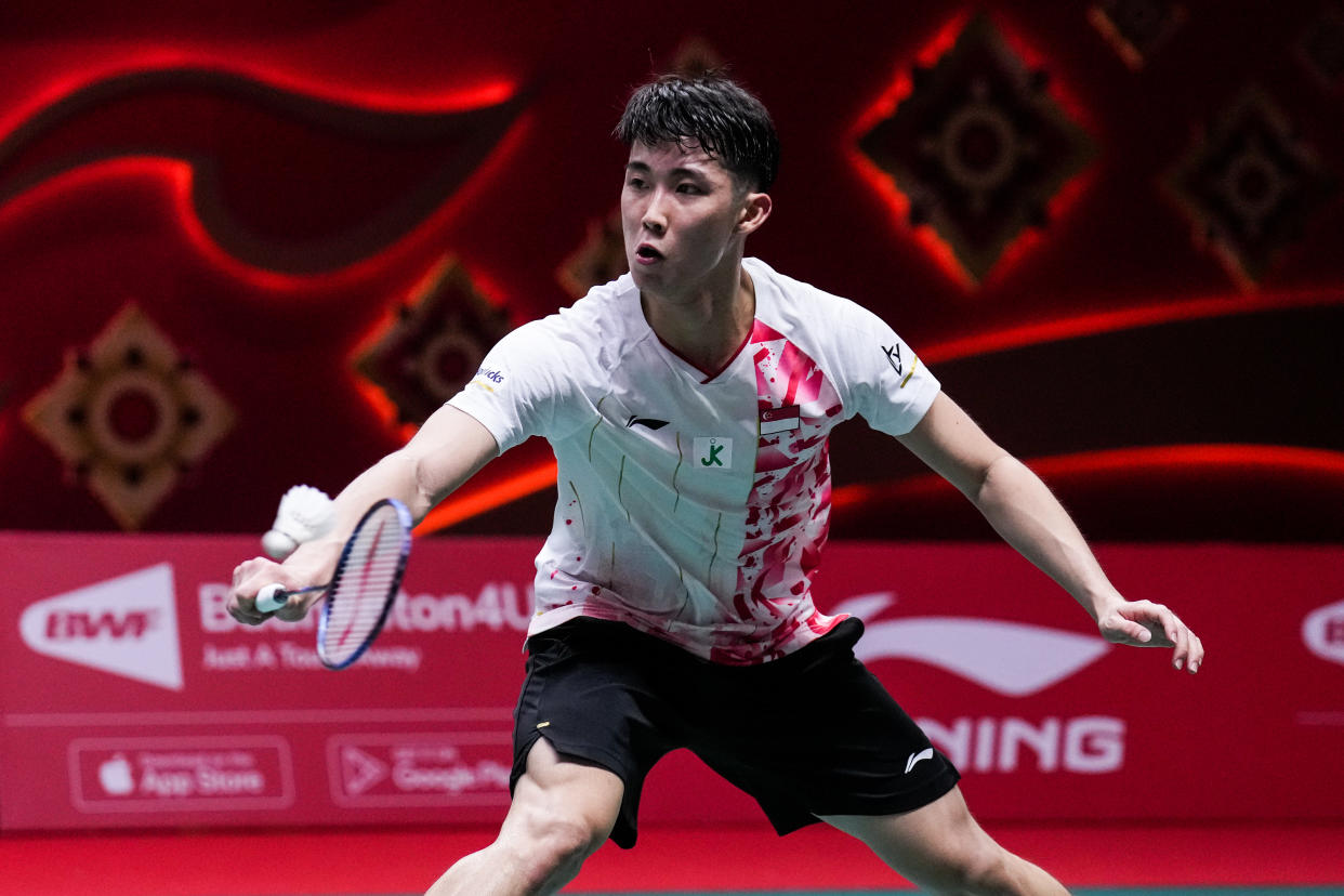 Singapore shuttler Loh Kean Yew retrieves a shot at the BWF World Tour Finals in Bangkok.