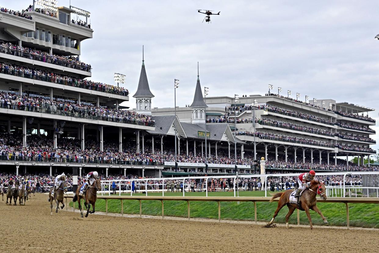 May 7, 2022; Louisville, KY, USA; Sonny Leon aboard Rich Strike rounds the first turn after winning the 148th running of the Kentucky Derby at Churchill Downs. Mandatory Credit: Jamie Rhodes-USA TODAY Sports