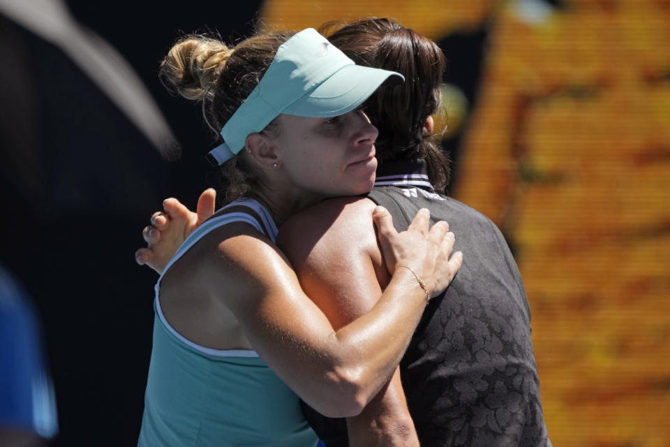 Magda Linette, left, of Poland embraces Caroline Garcia of France following their fourth round match at the Australian Open tennis championship in Melbourne, Australia, Monday, Jan. 23, 2023. (AP Photo/Aaron Favila)