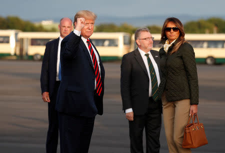 U.S. President Donald Trump pumps his fist as he and first lady Melania Trump arrive in Glasgow, Scotland, Britain July 13, 2018. REUTERS/Kevin Lamarque