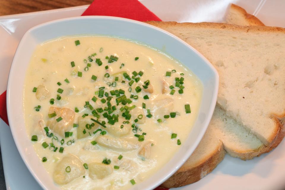 cullen skink soup in a triangluar bowl paired with bread on a platter