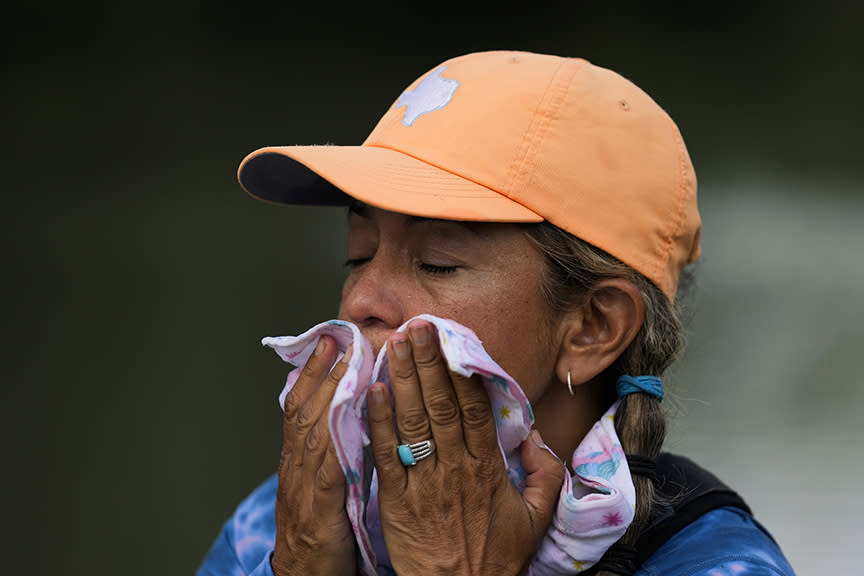 woman wipes her face