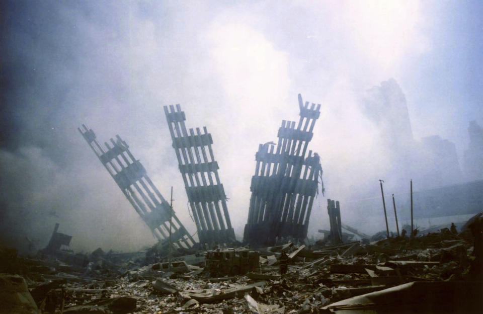 FILE - The remains of the World Trade Center stand amid other debris following the terrorist attack on the buildings in New York on Tuesday, Sept. 11, 2001. Twenty first century conspiracy theories reflect a distrust and an unease with the rapid pace of economic, technological and environmental change. There are claims that the Sept. 11, 2001 attacks were an inside job. (AP Photo/Alexandre Fuchs, File)