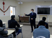 Chinese lecturer, Zhiwei Hu speaks to students in the Chinese language department at Salahaddin University in Irbil, Iraq, Wednesday, Jan. 19, 2021. The Chinese language school in northern Iraq is attracting students who hope to land jobs with a growing number of Chinese companies in the oil, infrastructure, construction, and telecommunications sectors in the region. (AP Photo/Khalid Mohammed)