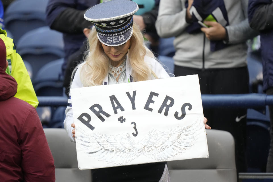 A fan holds a sign in honor of Buffalo Bills safety Damar Hamlin before an NFL football game between the Seattle Seahawks and the Los Angeles Rams Sunday, Jan. 8, 2023, in Seattle. (AP Photo/Stephen Brashear)