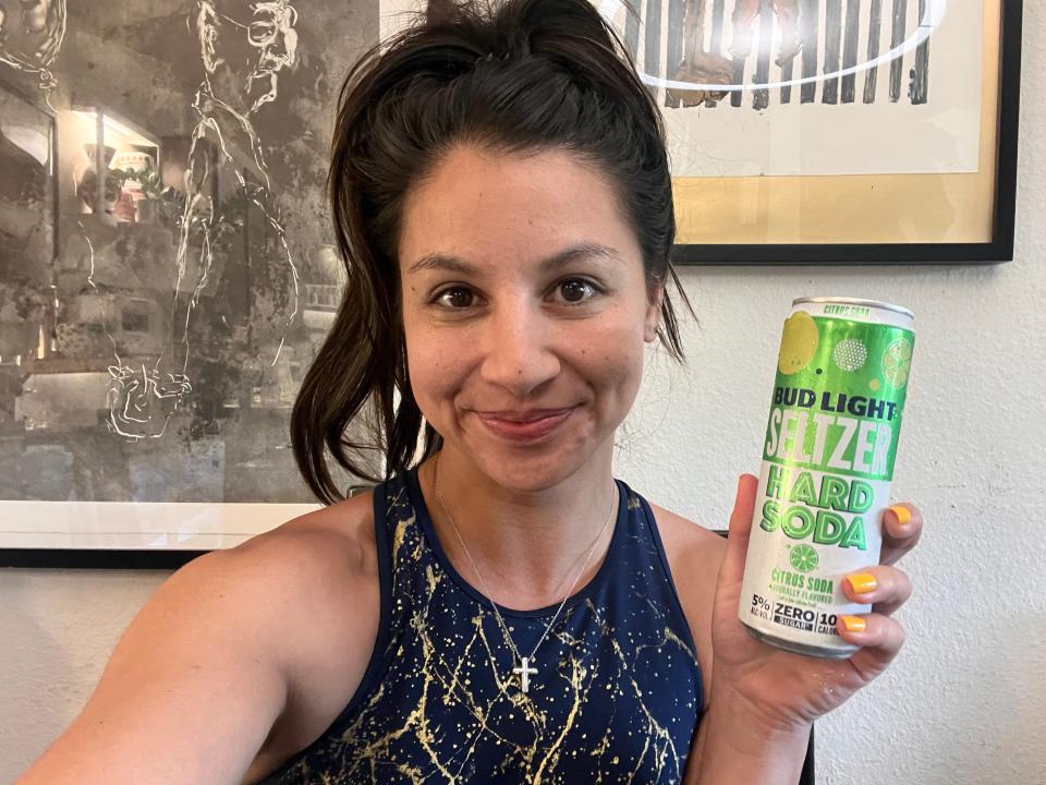 chelsea holding a can of lime bud light seltzer