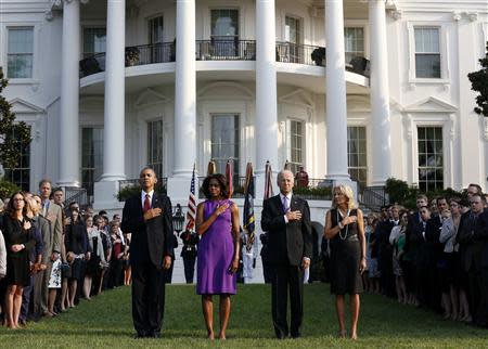 REFILE - CORRECTING BYLINE U.S. President Barack Obama, first lady Michelle Obama, Vice President Joe Biden and Jill Biden (L-R) pause for a moment of silence on the 12th anniversary of the attacks of September 11, 2001, on the South Lawn of the White House in Washington, September 11, 2013. REUTERS/Larry Downing