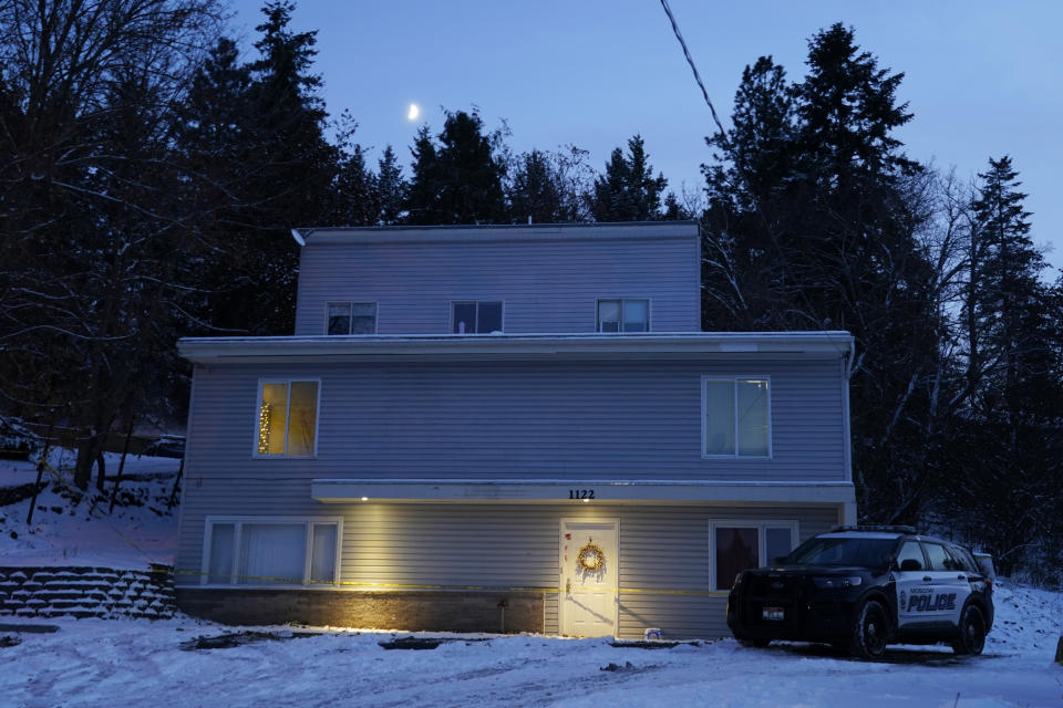 FILE - The moon rises on Nov. 29, 2022, as a Moscow police officer stands guard in his vehicle at the home where four University of Idaho students were found dead on Nov. 13, 2022 in Moscow, Idaho. It's been nearly three weeks since four University of Idaho students were found stabbed to death in a home near campus, but there are still more questions than answers surrounding the investigation. (AP Photo/Ted S. Warren, File)