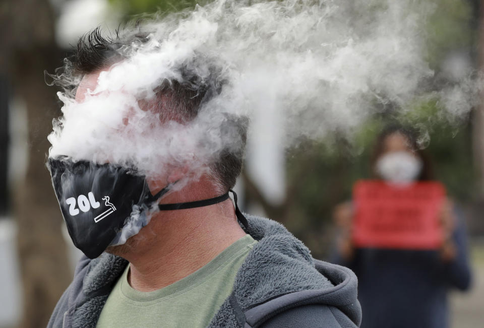 FILE — In this June 2, 2020 file photo demonstrators protest against the tobacco ban outside parliament in Cape Town, South Africa. South Africa is three months into a ban on the sale of cigarettes and other tobacco products, an unusual tactic employed by a government to protect the health of its citizens during the coronavirus pandemic. The country is one of just a few around the world to have banned tobacco sales during the pandemic and the only one to still have it in place. (AP Photo/Nardus Engelbrecht/File)