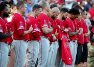 Members of the Los Angeles Angels hold the jersey of Tyler Skaggs #45 of the Los Angeles Angels during a moment of silence before taking on the Texas Rangers at Globe Life Park in Arlington on July 02, 2019 in Arlington, Texas. (Photo by Tom Pennington/Getty Images)