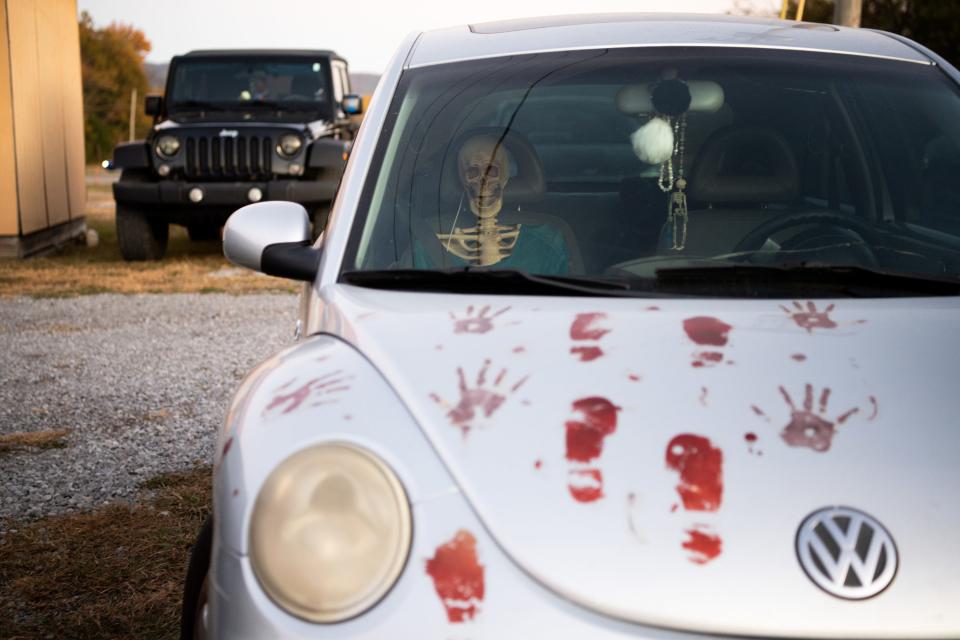 A skeleton sits in the passenger seat of a bloodied Volkswagen Beetle at the Knoxville Horror Film Fest at the Parkway Drive-In in Maryville on Friday, Oct. 21, 2022. 