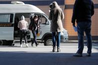 People queue outside a mobile laboratory for coronavirus disease testing near an airport in Saint Petersburg